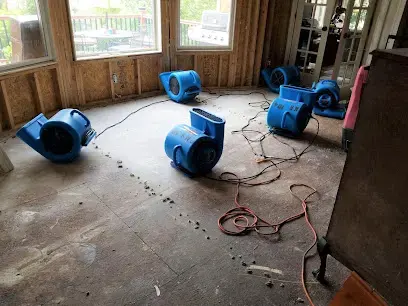 Air movers drying a stripped floor after water damage in Overland Park