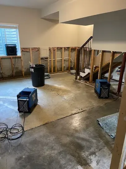 Basement with walls opened and dehumidifiers running in Overland Park