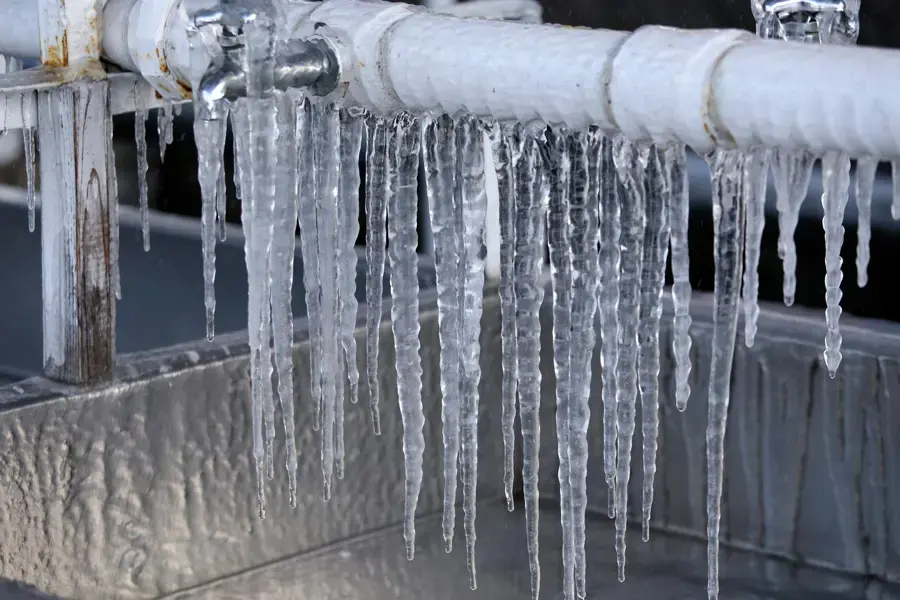 Icicles hanging from frozen water pipes after a hard freeze